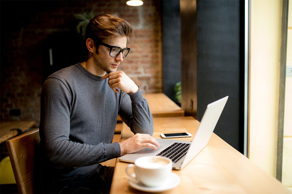 Paradigm Principles Financial Planning - Very dedicated student studying at a coffee shop