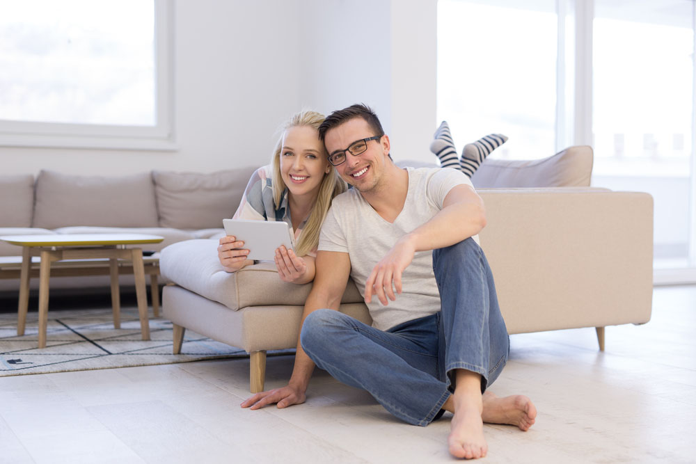 Paradigm Principles Financial Planning - Young couple on the sofa relaxing comfortably