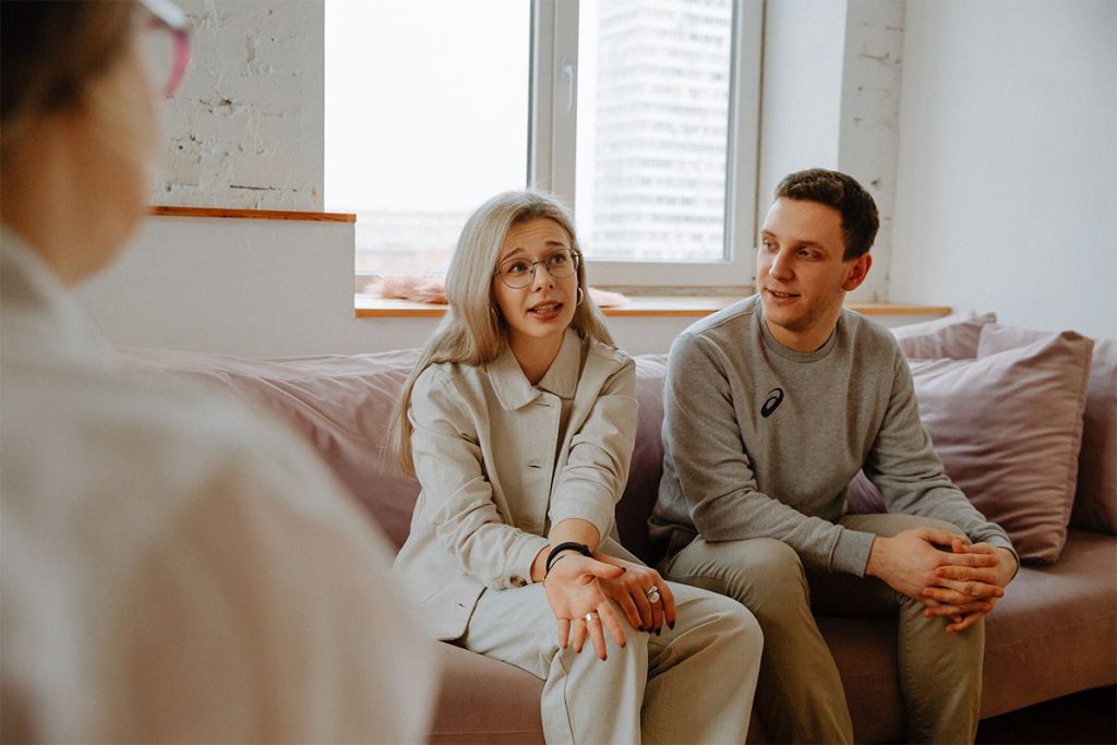 Paradigm Principles Financial Planning - Young couple talking with their financial adviser